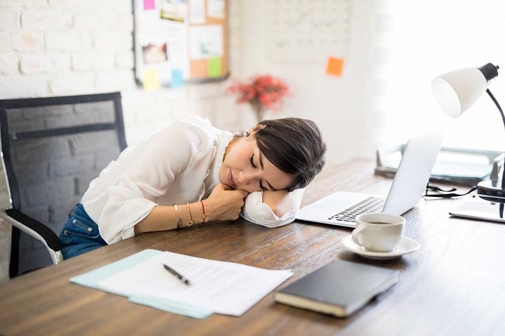 woman taking a nap at her desk